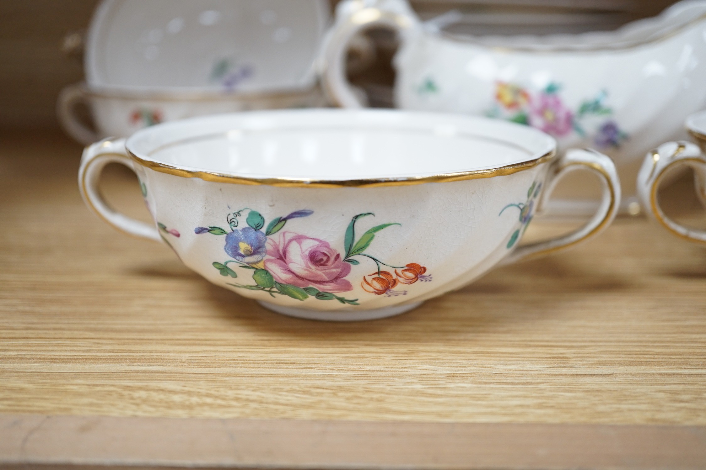 A part Clarice Cliff dinner set. With soup bowls, gravy bowl, etc. with flower decoration